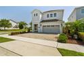 Attractive two-story home showcasing a brick driveway, gray garage door, and well-maintained landscaping at 341 Burma St, Kissimmee, FL 34747