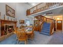 A dining room with a high ceiling, fireplace, and staircase that leads to the second floor at 4019 Lake Mirage Blvd, Orlando, FL 32817