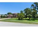 A charming two-story house with a well-manicured lawn, mature trees, and a spacious front yard at 4019 Lake Mirage Blvd, Orlando, FL 32817