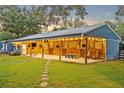 Spacious barn with covered porch, charming lighting, and ample space at 595 Seminole Woods Blvd, Geneva, FL 32732
