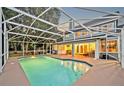Inviting screened-in pool area, perfect for relaxation and entertaining in the backyard at 595 Seminole Woods Blvd, Geneva, FL 32732