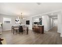 The dining room and kitchen feature an open-concept design with modern lighting and sleek countertops at 612 Florida Ave, St Cloud, FL 34769
