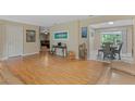Open concept living room with hardwood floors and access to dining area at 750 W May St, Deland, FL 32720
