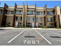 Stunning exterior of a modern townhome with sleek glass balconies, lush landscaping and convenient parking at 7667 Recife Dr, Kissimmee, FL 34747