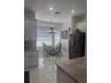 Eat-in dining space with modern lighting, white cabinets, granite countertops, and black stainless steel appliances at 802 Kaywood Dr, Orlando, FL 32825