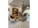 Inviting living room with tile floors, chandelier, comfortable seating, and access to outdoor space at 802 Kaywood Dr, Orlando, FL 32825