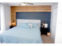 Main bedroom with a modern headboard, decorative lighting, a ceiling fan, and large window at 944 Park Terrace Cir, Kissimmee, FL 34746