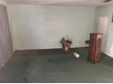 Spacious living room features neutral wall and carpet tones with natural light; in need of refurbishment at 977 E Normandy Blvd, Deltona, FL 32725