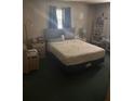 Main bedroom with plush bedding, carpet, natural lighting, and ample space, ready for transformation at 977 E Normandy Blvd, Deltona, FL 32725
