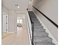 Elegant staircase with dark wood accents and neutral carpet, leading to the upper level at 10172 Hadley St, Orlando, FL 32829