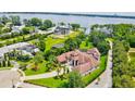 Beautiful aerial view of a waterfront property, showcasing the landscape, pool, and lake access at 10352 Burris Ct, Orlando, FL 32836