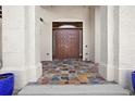 Inviting entryway with colorful tiled floor and large columns framing the front door at 10352 Burris Ct, Orlando, FL 32836