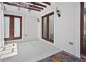 Covered outdoor patio with dual doors and concrete flooring at 10352 Burris Ct, Orlando, FL 32836