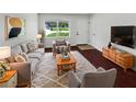 Bright living room with plush seating, large window, and stylish decor for a comfortable and inviting atmosphere at 14837 Sussex Dr, Orlando, FL 32826