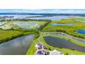 Stunning aerial view of the expansive property featuring multiple ponds and lush greenery, backing onto a large lake at 15208 Lake Claire Overlook Dr, Winter Garden, FL 34787