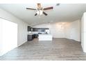 Open-concept living area and kitchen with modern stainless appliances and dark cabinets at 15476 Sw 34Th Court Rd, Ocala, FL 34473