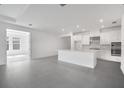 Bright, open kitchen features stainless steel appliances, an island with sink, and ample cabinet space at 16041 Honey Harvest St, Winter Garden, FL 34787