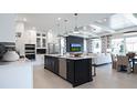 Bright, open kitchen with a center island, modern appliances, and easy access to the living and dining areas at 1618 Bellagio Loop, Tavares, FL 32778