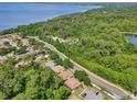 Aerial view of the community with lake view, surrounded by lush greenery and convenient parking at 168 Perimeter Ct # 5C, Deltona, FL 32725