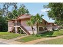 Inviting two-story condo with stairs to the second level and lush lawn at 168 Perimeter Ct # 5C, Deltona, FL 32725