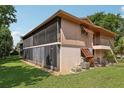 A charming exterior elevation showcasing the home's facade and screened-in porch at 168 Perimeter Ct # 5C, Deltona, FL 32725