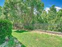 A serene backyard featuring lush greenery and a well-maintained fence at 1757 Sunset Palm Dr, Apopka, FL 32712