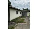 Picture of the home's rear exterior showing its compact yard and white concrete block construction at 1822 Williams Manor Ave, Orlando, FL 32811