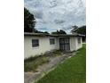 Image of the home's back exterior including a fenced entrance and a compact yard at 1822 Williams Manor Ave, Orlando, FL 32811