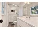 Modern bathroom featuring a glass-enclosed shower, white subway tile, and a stylish vanity at 2320 Wekiva Ridge Rd, Apopka, FL 32712