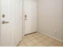 Clean foyer with tile flooring and a secure entrance featuring a coded lock at 2493 Lancien Ct # 5, Orlando, FL 32826