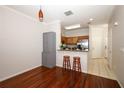 Open-concept kitchen area with stainless steel appliances, granite countertops, and hardwood flooring at 2493 Lancien Ct # 5, Orlando, FL 32826