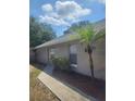 Exterior view of a house with a well-maintained walkway and landscaping at 2723 Talladega Dr, Orlando, FL 32826