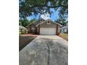 Two-story home featuring a two-car garage and well-maintained front yard at 2723 Talladega Dr, Orlando, FL 32826