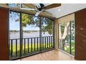 Cozy screened porch featuring serene lake views and wood flooring at 2945 Lake Pineloch Blvd # 18-26, Orlando, FL 32806