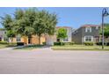 Street view showcasing well-maintained homes and landscaping in the neighborhood at 2985 Buccaneer Palm Rd, Kissimmee, FL 34747