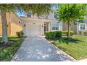 Inviting home with a lush green lawn and a spacious driveway at 2985 Buccaneer Palm Rd, Kissimmee, FL 34747