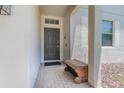 Welcoming front porch featuring tiled flooring and a stylish bench at 2985 Buccaneer Palm Rd, Kissimmee, FL 34747