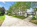 Exterior of a white condominium building behind a black gated entrance and lush green landscape at 4114 Breakview Dr # 30702, Orlando, FL 32819