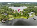 Breathtaking aerial view of a lakefront property surrounded by lush greenery, showcasing its serene setting and prime location at 4536 N Landmark Dr, Orlando, FL 32817