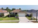 Lovely single-story home with an attached two-car garage, complimented by green lawn and landscaping at 4553 Baler Trails Dr, St Cloud, FL 34772