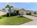 Inviting home featuring lush landscaping, a green lawn, and a convenient two-car garage at 4553 Baler Trails Dr, St Cloud, FL 34772