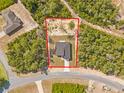 Aerial view showcasing the property boundaries and the modern single-story home surrounded by lush greenery at 501 Marion Oaks Golf Way, Ocala, FL 34473