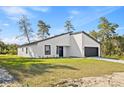 Attractive one-story home showcasing modern architectural design with a white exterior and black accents at 501 Marion Oaks Golf Way, Ocala, FL 34473