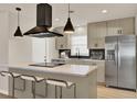 Bright kitchen with stainless steel appliances, large island, and pendant lighting at 5210 Poinsetta Ave, Winter Park, FL 32792