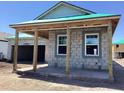 Exterior of a block construction home with a covered porch and windows framed in white at 5706 Cattle Ranch Drive, St Cloud, FL 34771