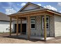 New home exterior with an unfinished front porch and two-car garage at 5706 Cattle Ranch Drive, St Cloud, FL 34771