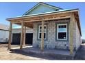 Exterior of a block construction home with a covered porch and windows framed in white at 5706 Cattle Ranch Drive, St Cloud, FL 34771