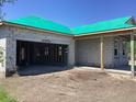 View of new construction with a green roof and block construction with unfinished garage at 5706 Cattle Ranch Drive, St Cloud, FL 34771