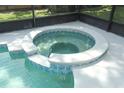 Close-up of a hot tub with blue accents sitting next to a sparkling pool, perfect for relaxation at 645 Peachwood Dr, Altamonte Springs, FL 32714
