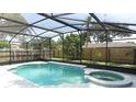 The backyard features a screened-in pool and a jacuzzi with a fenced in yard perfect for relaxation and entertaining at 645 Peachwood Dr, Altamonte Springs, FL 32714